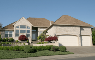 Modern suburban home with manicured landscaping, arched windows, and a three-car garage—featured in a blog by Jacksonville Realtor® Erin E. King, MBA, on active buyer demand in today’s market.