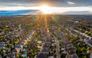 A rising sun shown as a beacon to real estate consumers looking into the future.